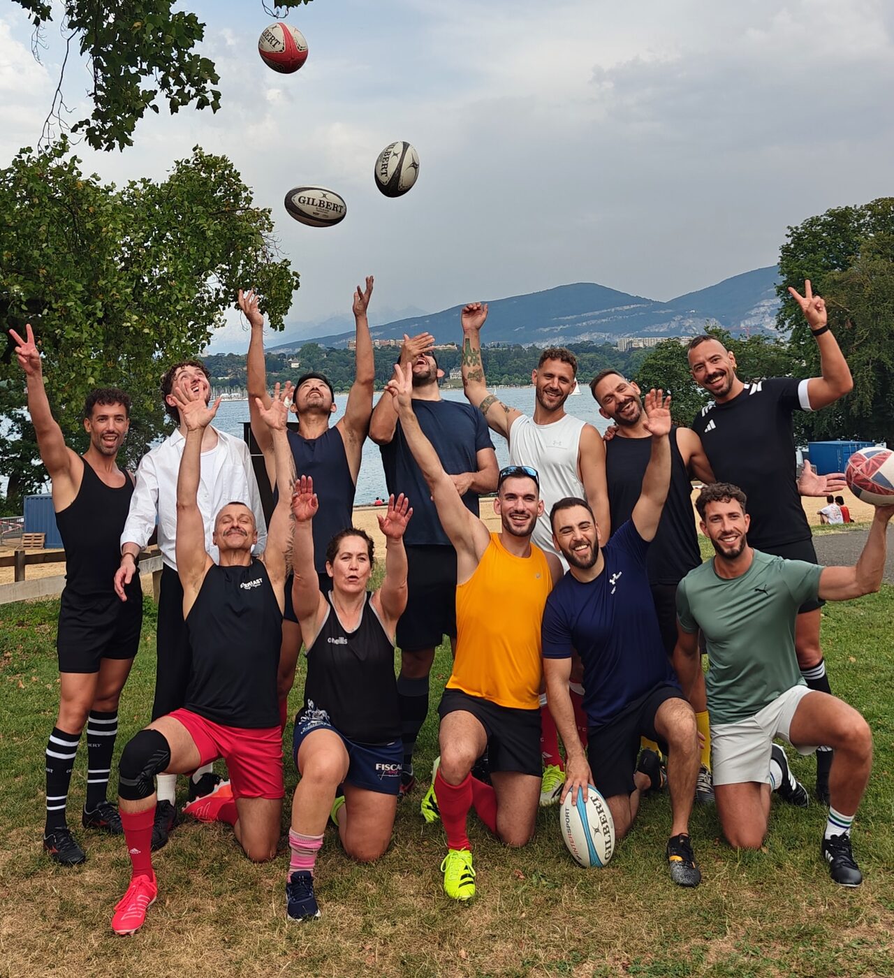 Geneva Guardians players tossing rugby balls beside Lake Geneva